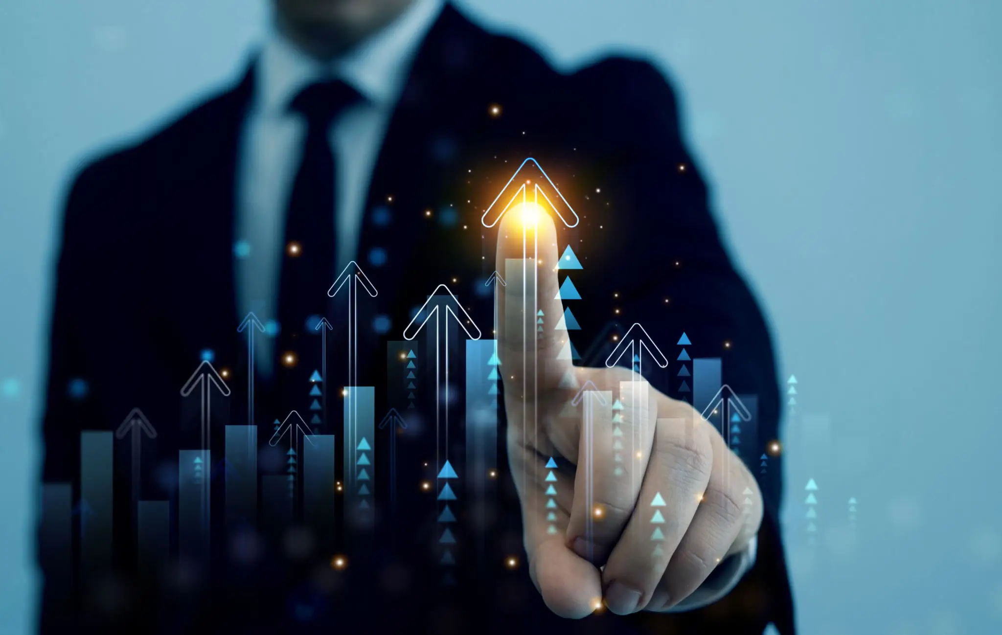 Businessman pointing to a glowing upward arrow symbolizing growth.