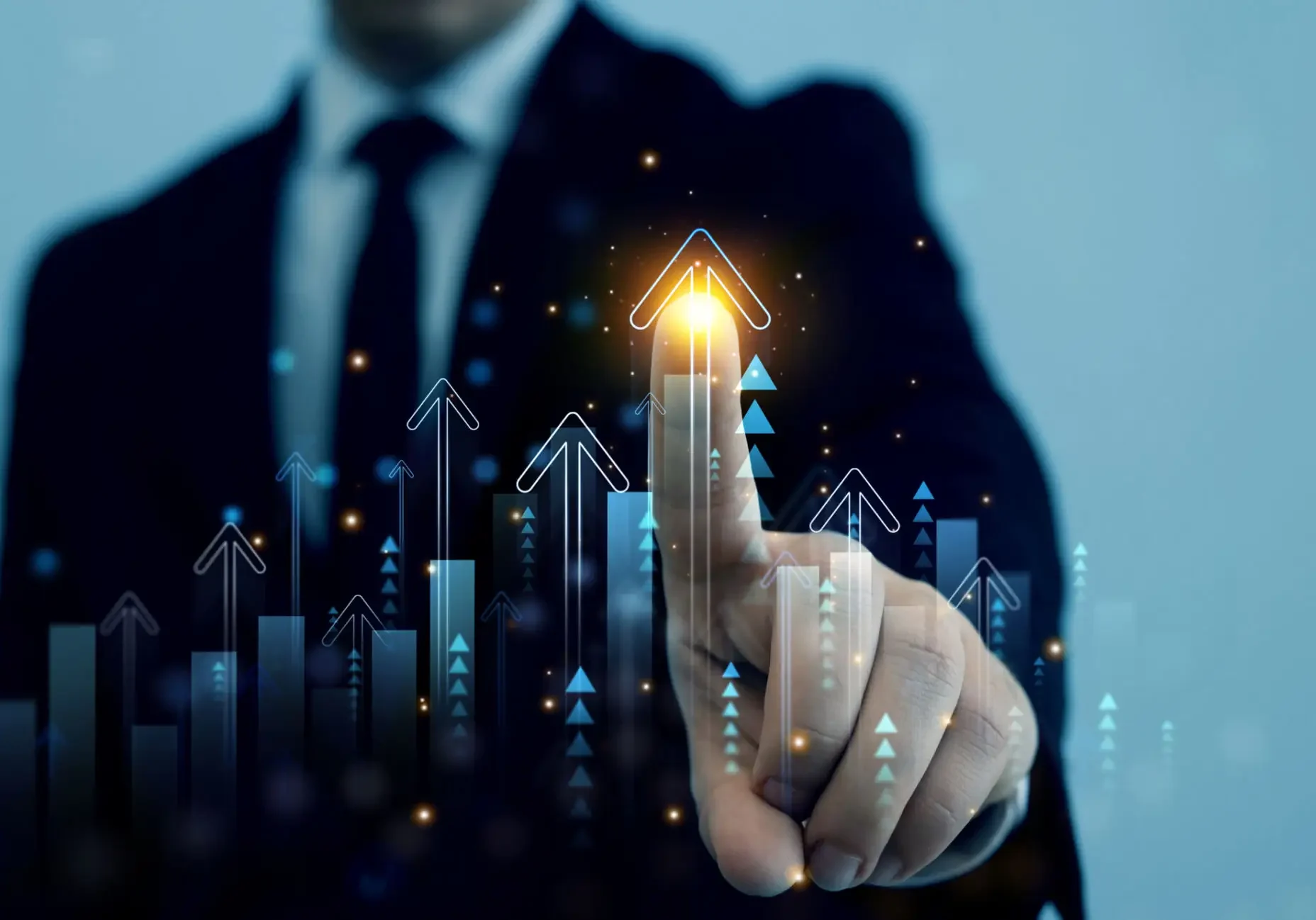 Businessman pointing to a glowing upward arrow symbolizing growth.