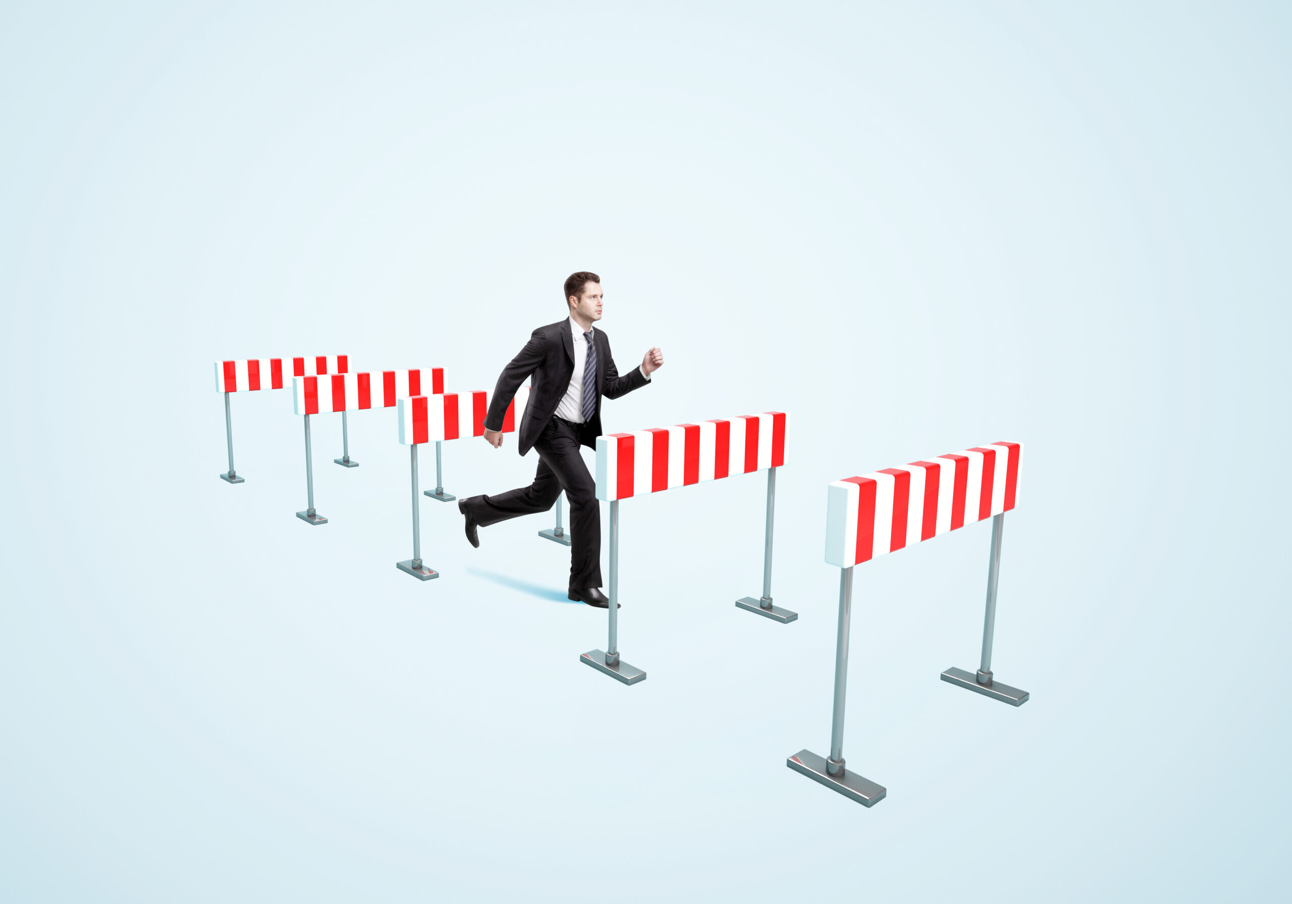 businessman jumping over barrier  on a blue background